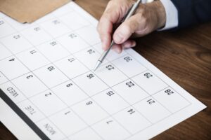 Businessman marking a date on a calendar