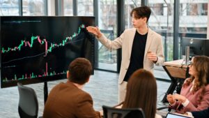 Young Worker Leading Business Meeting About Cryptocurrencies In An Office